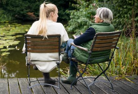 woman and older woman talk in the park 