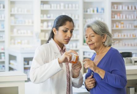 Woman talking with pharmacist about getting prescription filled