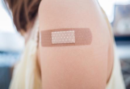 Photo: Woman's upper arm with bandage