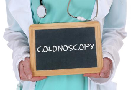 Doctor holding sign: Colonoscopy