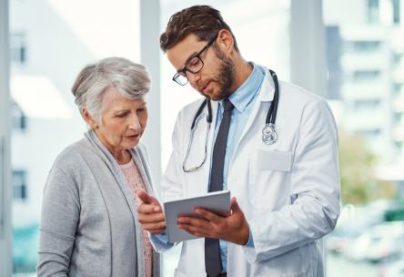 Doctor talking over Medicare Advantage or Medigap with patient