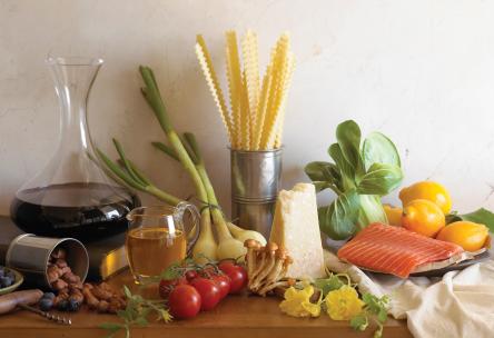 Photo: Display of foods: lemons, salmon, tomatoes, cheese, dry pasta, leeks, bok choy.