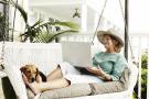 Photo: Woman sitting outside with dog on laptop