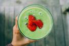 Green smoothie topped with strawberries