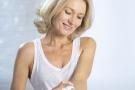 Woman applying CBD cream to arm