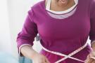 Photo: Woman measuring waist line