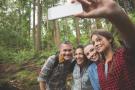Family on a hike taking a selfie.