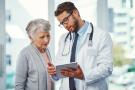 Doctor talking over Medicare Advantage or Medigap with patient