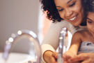 Mother and daughter washing hands in sink